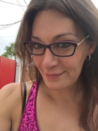 a woman wearing glasses and a pink bikini top